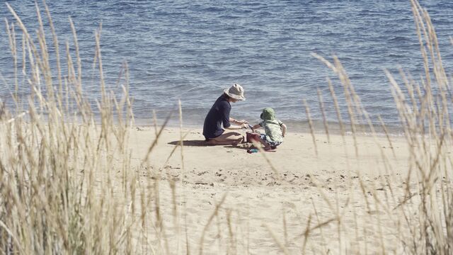 Mother and child playing on beach SMALL